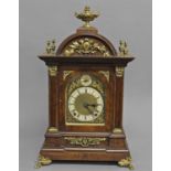 A GERMAN WALNUT BRACKET CLOCK, the 5" dial with silvered chapter ring and Roman numerals below a