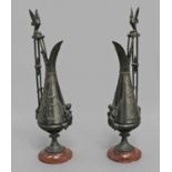 A PAIR OF EMPIRE STYLE BRONZE EWERS, late 19th century, each with a twin stem handle surmounted by a