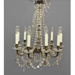 A 19TH CENTURY CHANDELIER for nine lights with brass scroll branches and moulded glass stem with