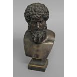 AFTER THE ANTIQUE; a French cast and patinated bronze bust of a man with bushy curly hair and beard,