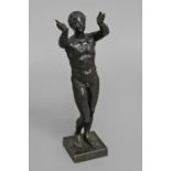 AFTER THE ANTIQUE; a Roman style cast and patinated bronze statue of a naked young man standing with