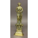 A BRASS FIGURAL DOOR STOP, in the form of a Classical female figure raised on a swagged plinth,
