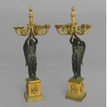 A PAIR OF BRONZE AND GILT BRONZE FIGURAL CANDELABRA, the five scrolling gilt branches with