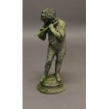 A LEAD FIGURE OF A YOUNG BOY, playing an instrument, on an oval stepped base, height 59cm