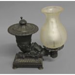 AN EARLY 19TH CENTURY COLZA OIL LAMP, the body in the form of a lidded cornucopia with a boars