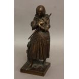 FRENCH SCHOOL, a patinated bronze figure of Joan of Arc, modelled standing with arms crossed, helmet