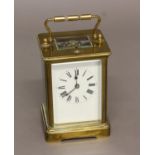 A FRENCH BRASS CARRIAGE CLOCK, the enamelled dial on a brass eight day movement stamped 'B.T.G',