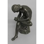 AFTER THE ANTIQUE; an 18th or 19th century cast and patinated bronze study of Spinario, seated on