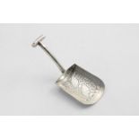 A GEORGE III CADDY SPOON in the form of a shovel with an engraved bowl and a hollow T-shaped handle,