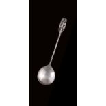 A RARE GEORGE V IRISH ARTS AND CRAFTS SPOON with a hammered, near circular bowl, a chased leaf