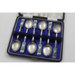 A GEORGE VI CASED SET OF SIX TEA SPOONS with enamelled terminals resembling stylised seed pods, by