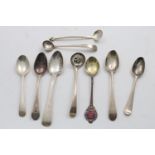 A MIXED LOT:- A George III picture-back tea spoon, a tea spoon by Hester Bateman, another by Peter &