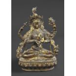 SINO TIBETAN BRONZE BUDDHA a gilded bronze female deity, the figure with four arms and sitting