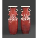 CHINESE SANG DE BOEUF VASES late 19thc, a pair of vases with a sang de boeuf glaze, with applied