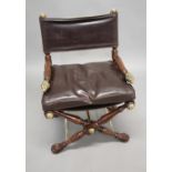 THEODORE ALEXANDER - CONTEMPORARY X FRAMED LEATHER & BRASS ARMCHAIR the chair with a wooden X