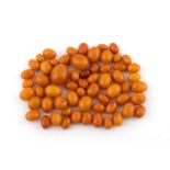 A QUANTITY OF LOOSE AMBER BEADS 108 grams