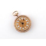 AN ENAMEL AND GOLD OPEN FACED FOB WATCH the gold coloured dial with Arabic numerals (glass missing),