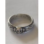 A GERMAN THIRD REICH HONOUR RING. A silver ring with central Totenkopf skull and bones, the band