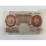 A BANK OF ENGLAND TEN SHILLING NOTE. A Series 'A' Bank of England 10 shilling note B94 605830 signed