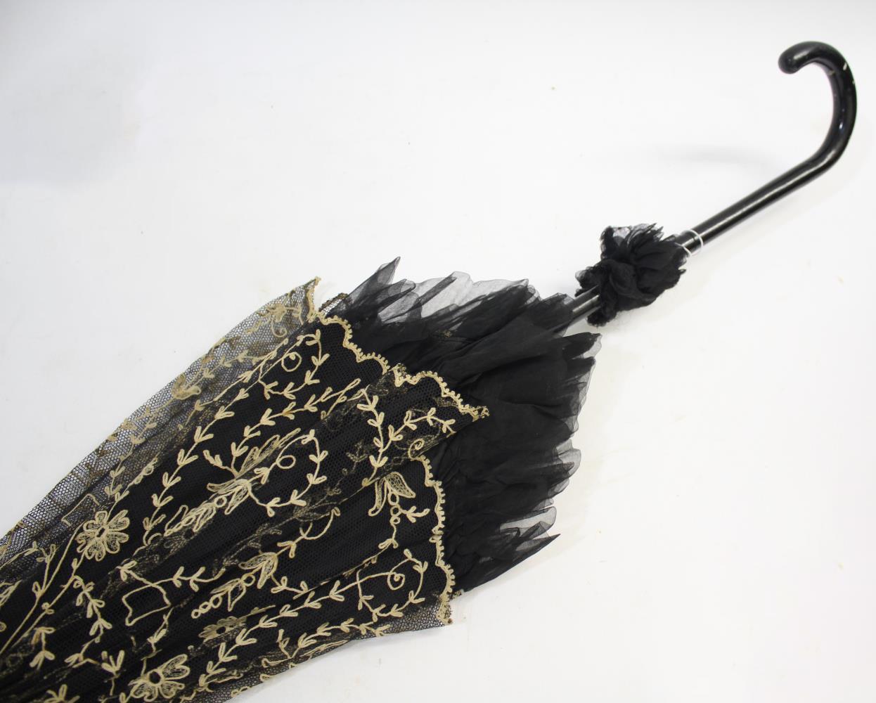 VICTORIAN LACE PARASOL a black and cream silk parasol with a wooden handle.