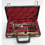 CASED OBOE - BUSSON an ebonised oboe in three sections, in a fitted case with spare reeds. Marked,