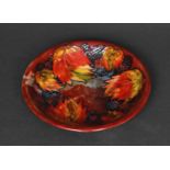 MOORCROFT FLAMBE PLATE - LEAF & BERRY a plate painted in the leaf & berry design and with a flambe