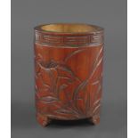 CHINESE BAMBOO BRUSH POT a circular brush pot supported on three feet, carved with flowers, leaves