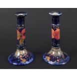 PAIR OF MOORCROFT CANDLESTICKS - POMEGRANATE a pair of William Moorcroft candlesticks, in the