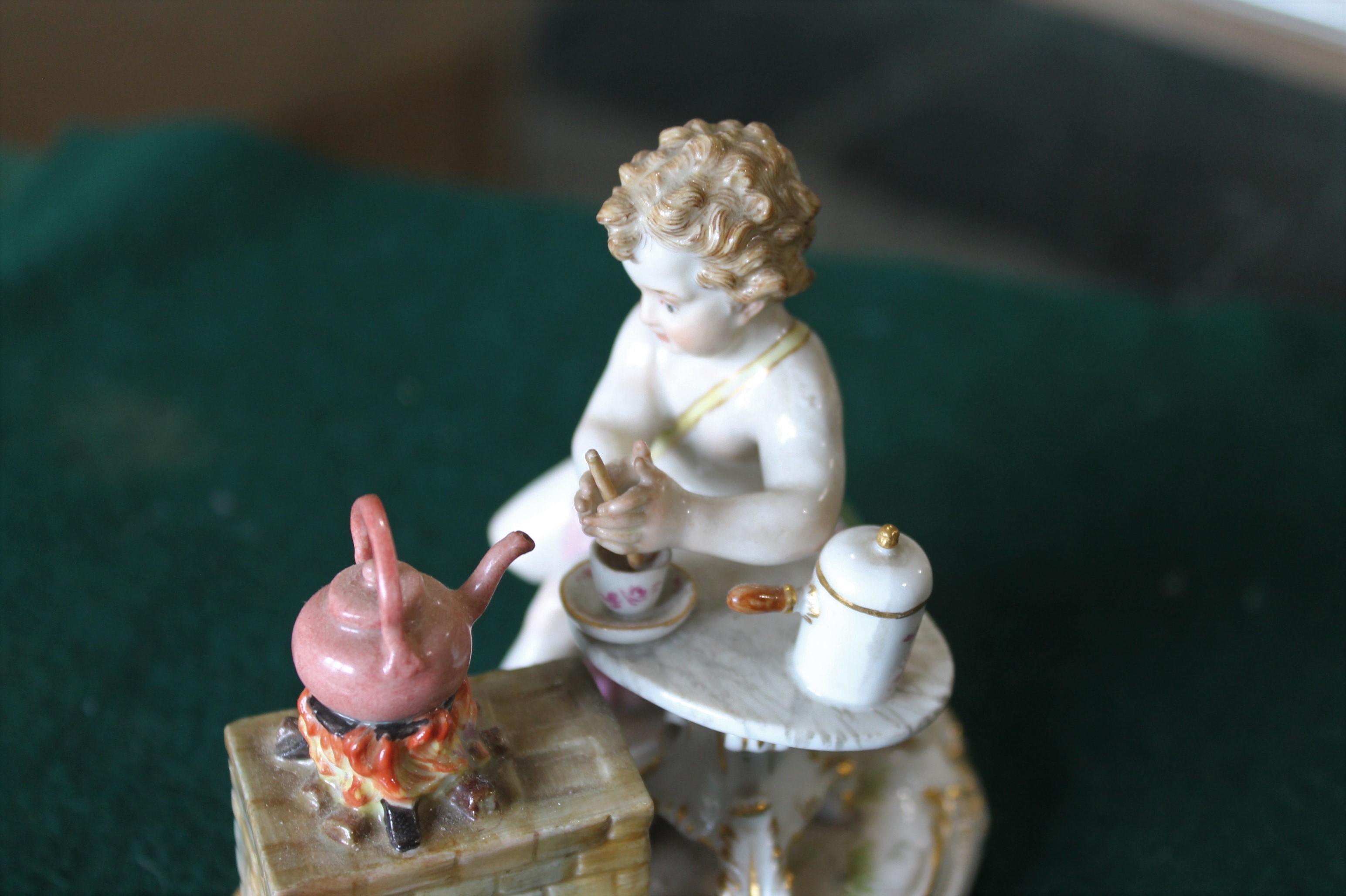 MEISSEN FIGURE a porcelain figure of a cherub mixing a drink, with a brazier and a kettle on a fire, - Image 8 of 13