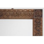 A STAINED PINE FRAME with a faceted cuboid outer edge, repeating heart-shaped motif on the frieze,
