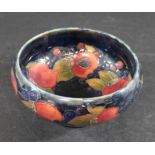WILLIAM MOORCROFT BOWL in the Pomegranate design on a blue ground. Painted signature and impressed