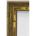 A FRENCH EMPIRE GILTWOOD PICTURE FRAME with raised stylised leaf and flowerhead decoration To fit 48