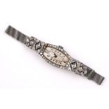 AN ART DECO LADY'S DIAMOND COCKTAIL WRISTWATCH the tonneau-shaped dial with Arabic numerals, with