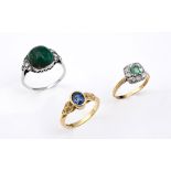 AN EMERALD AND DIAMOND CLUSTER RING the square-shaped emerald is set within a surround of circular-