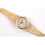 A LADY'S 9CT GOLD WRISTWATCH BY OMEGA the signed circular dial with baton numerals, Omega logo to