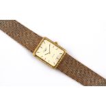 A LADY'S 9CT GOLD WRISTWATCH BY LONGINES the signed rectangular-shaped dial with baton numerals,