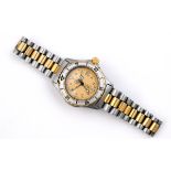 A LADY'S STAINLESS STEEL 1989 WORLD TOUR WRISTWATCH BY TAG HEUER the signed gold coloured dial