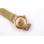 A LADY'S 18CT GOLD WRISTWATCH BY OMEGA the signed circular gold coloured dial with diamond