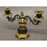 AN EMPIRE STYLE GILT AND BRONZE TWIN BRANCH CANDELABRA, the central urn form stem flanked by