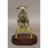 A BRASS SKELETON CLOCK the 4" shaped silvered chapter ring with Roman numerals on a single fusee