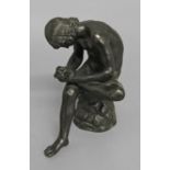 AFTER THE ANTIQUE; a 19th century cast and patinated bronze study of Spinario, seated on a tree