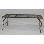 A WROUGHT IRON BLACKSMITHS COOLING TABLE, on trestle type legs, height 67cm, width 175cm, depth