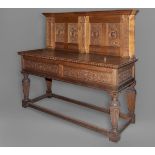 AN OAK SIDEBOARD, the carved panelled back with Corinthian columns and four panels each carved