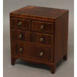 A MINIATURE MAHOGANY CHEST OF DRAWERS, with boxwood inlay and crossbanding, height 24cm