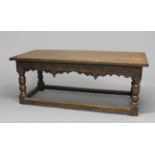 A 17TH CENTURY OAK SERVING TABLE, the carved frieze with turned finials, on turned bulbous