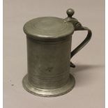 AN EARLY 18TH CENTURY PEWTER TANKARD, probably Continental, the lid dated 1733, the handle with