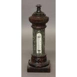 A SERPENTINE PILLAR THERMOMETER, the faceted column with a thermometer marked Negretti & Zambra,