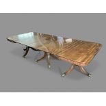 A LATE REGENCY MAHOGANY EXTENDING DINING TABLE, the rounded rectangular top on three turned and