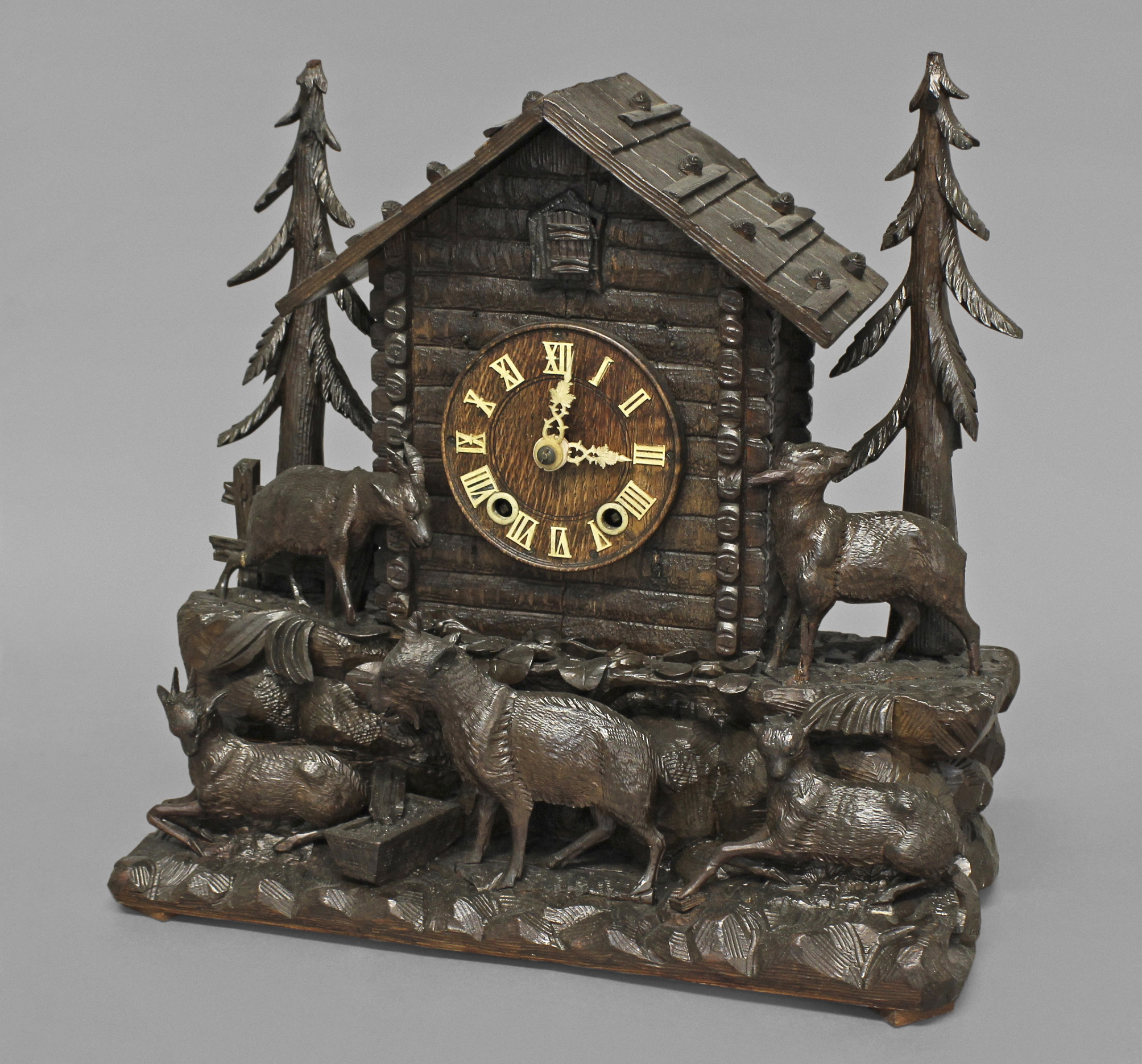 A BLACK FOREST CUCKOO CLOCK, the 5" wooden dial with Roman numerals on a brass eight day two train