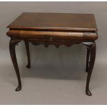 A WALNUT SIDE TABLE, 18th century and later, the feather-banded rectangular top (later) above a